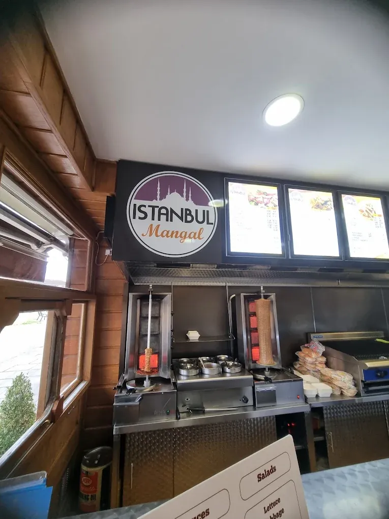 The kitchen at Istanbul Mangal with two doner spits turning beside the grill